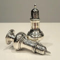 A pair of sterling silver salt and pepper shakers made by Gorham Manufacturing Co. No.SS141