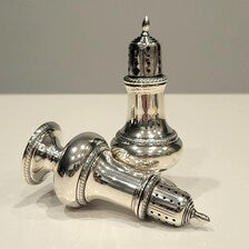 A pair of sterling silver salt and pepper shakers made by Gorham Manufacturing Co. No.SS141